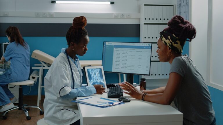 African american patient and doctor looking at radiography